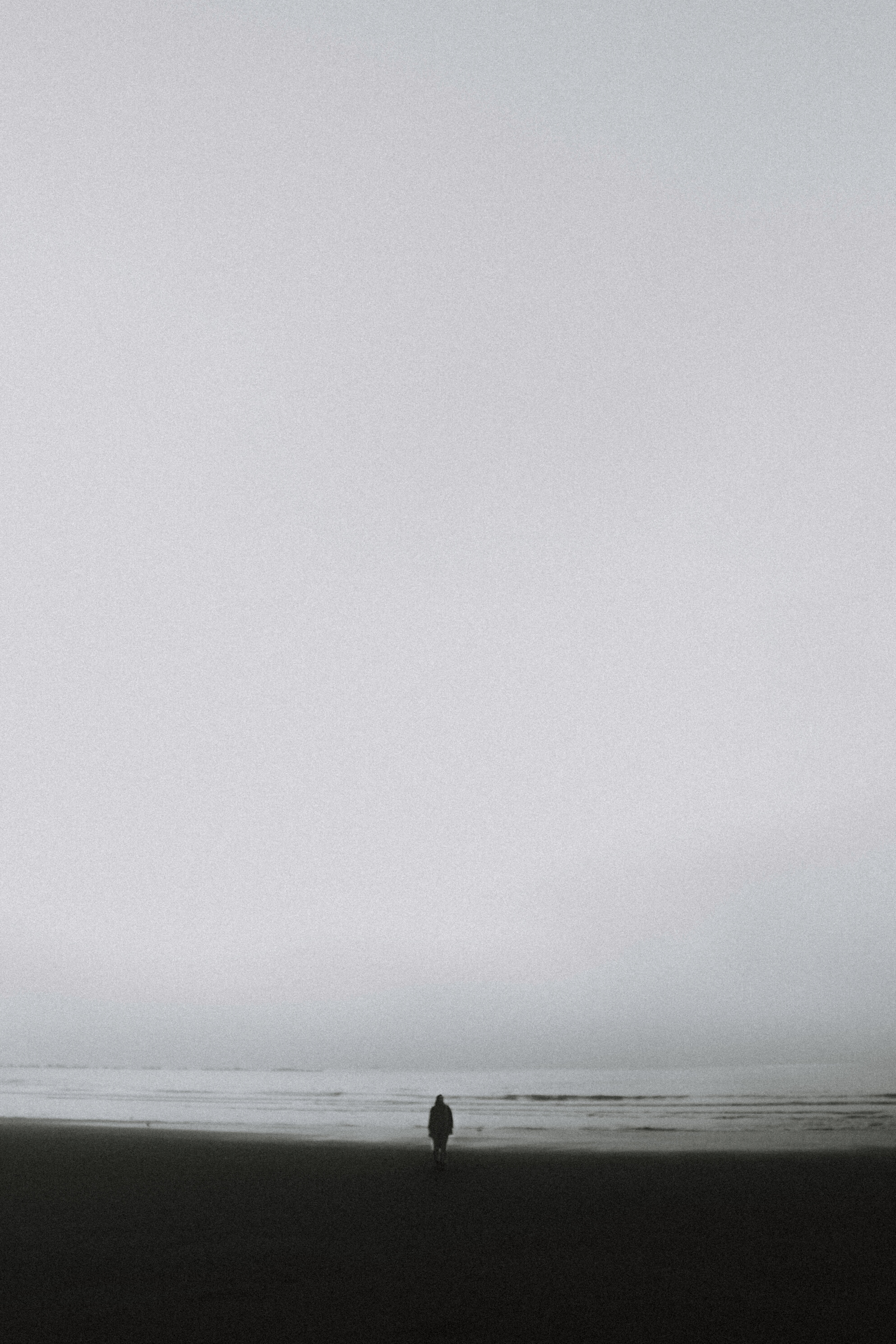 Lonely person standing on seashore